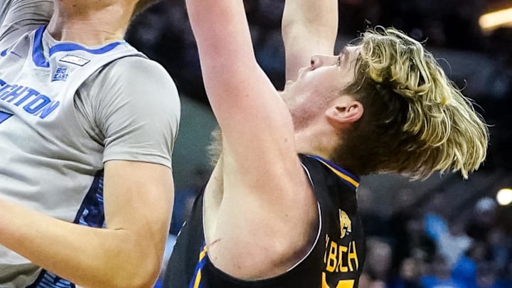 Creighton Bluejays center Ryan Kalkbrenner dunks the ball against UC Riverside Highlanders forward Lachlan Olbrich. Mandatory Credit: Dylan Widger-Imagn Images
