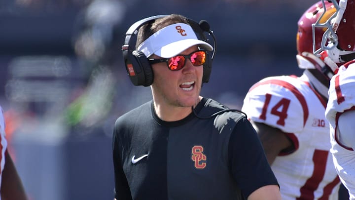 Sep 27, 2025; Champaign, Illinois, USA;  Southern California Trojans head coach Lincoln Riley talks with players during the first half against the Illinois Fighting Illini  at Memorial Stadium. Mandatory Credit: Ron Johnson-Imagn Images