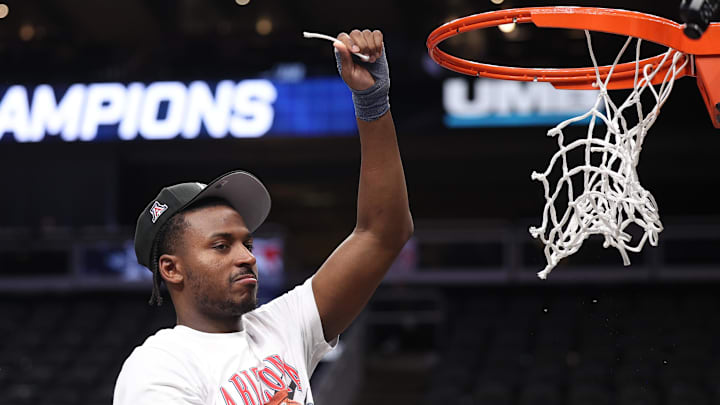 Mar 14, 2026; Kansas City, MO, USA; Arizona Wildcats guard Jaden Bradley (0) cuts the net following a win over the Houston Cougars during the men's Big 12 Conference Tournament Championship at T-Mobile Center. Mandatory Credit: William Purnell-Imagn Images Mar 14, 2026; Kansas City, MO, USA; Arizona Wildcats guard Jaden Bradley (0) cuts the net following a win over the Houston Cougars during the men's Big 12 Conference Tournament Championship at T-Mobile Center. Mandatory Credit: William Purnell-Imagn Images