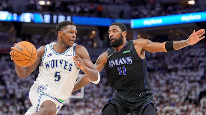 May 24, 2024; Minneapolis, Minnesota, USA; Minnesota Timberwolves guard Anthony Edwards (5) controls the ball against Dallas Mavericks guard Kyrie Irving (11) in the second quarter during game two of the western conference finals for the 2024 NBA playoffs at Target Center. Mandatory Credit: Brad Rempel-Imagn Images