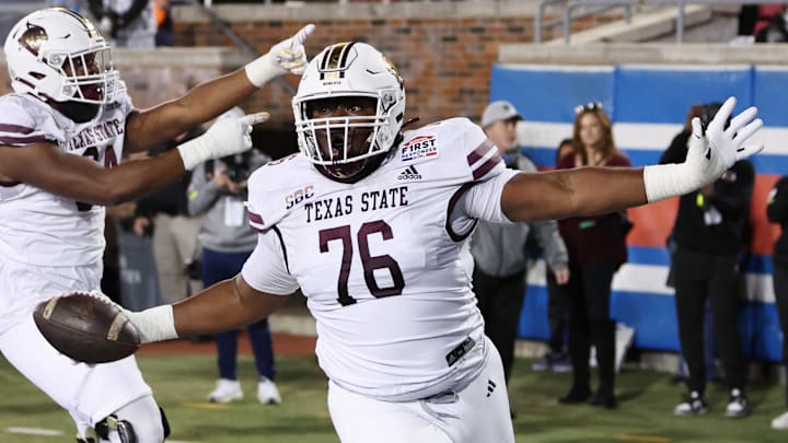 Dec 26, 2023; Dallas, TX, USA; Texas State Bobcats offensive lineman Nash Jones (76) scores a touchdown against the Rice Owls in the second half at Gerald J Ford Stadium.