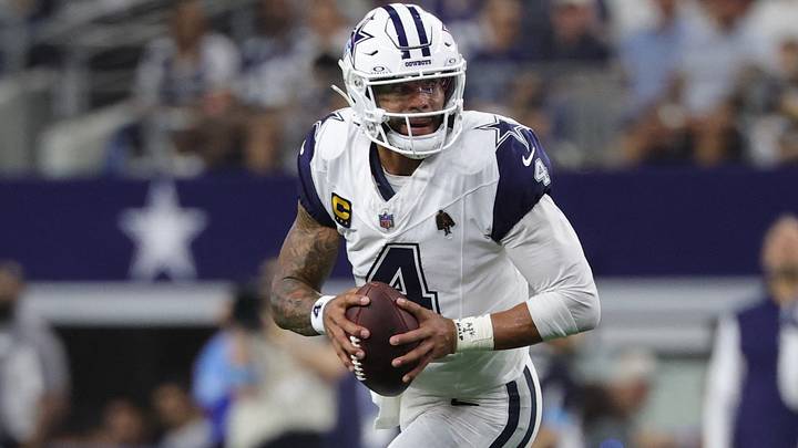 Dallas Cowboys quarterback Dak Prescott scrambles against the Washington Commanders defense. Dallas Cowboys quarterback Dak Prescott scrambles against the Washington Commanders defense.