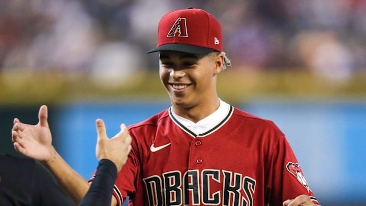 Diamondbacks Draft Druw Jones, right, shakes hands with Arizona Diamondbacks center fielder Alek Thomas (5), left, after throwing the opening pitch before the game against the Washington Nationals at Chase Field on Saturday, July 23, 2022, in Phoenix.

Uscp 7lzxvqcipg7dt8x01rk2 Original