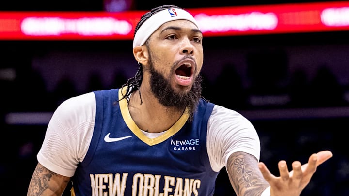 Dec 5, 2024; New Orleans, Louisiana, USA;  New Orleans Pelicans forward Brandon Ingram (14) reacts to a play against Phoenix Suns guard Devin Booker (1) during the first half  at Smoothie King Center. Mandatory Credit: Stephen Lew-Imagn Images