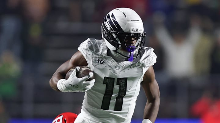 Oct 18, 2025; Piscataway, New Jersey, USA; Oregon Ducks wide receiver Jeremiah McClellan (11) is tackled by Rutgers Scarlet Knights defensive back Kevin Levy (24) during the second half at SHI Stadium. Oct 18, 2025; Piscataway, New Jersey, USA; Oregon Ducks wide receiver Jeremiah McClellan (11) is tackled by Rutgers Scarlet Knights defensive back Kevin Levy (24) during the second half at SHI Stadium.