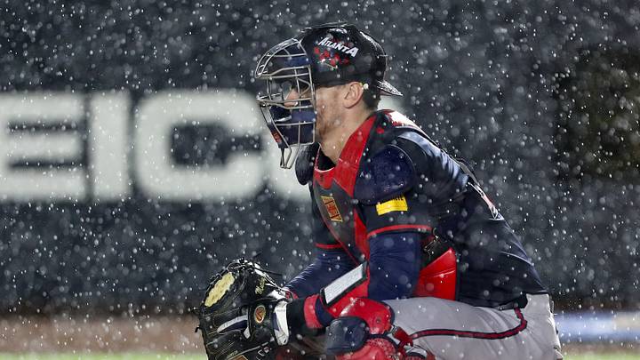 Aug 2, 2025; Bristol, Tennessee, USA; Atlanta Braves catcher Sean Murphy (12) prepares to defend the plate as rain falls during the first inning of the Speedway Classic game against the Cincinnati Reds at Bristol Motor Speedway. Mandatory Credit: Randy Sartin-Imagn Images