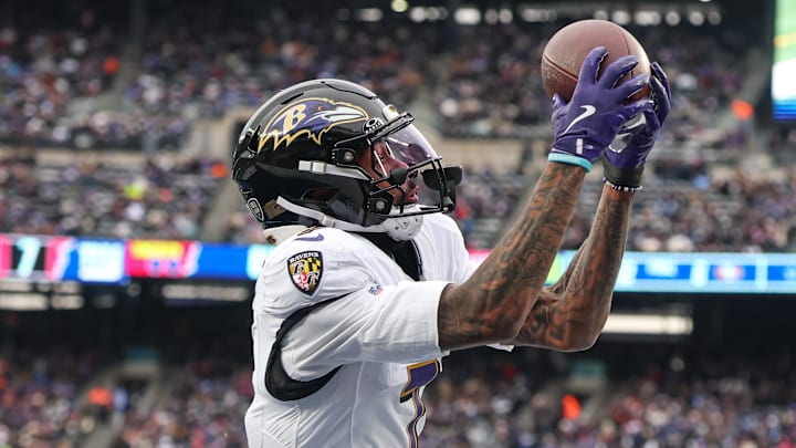 Dec 15, 2024; East Rutherford, New Jersey, USA; Baltimore Ravens wide receiver Rashod Bateman (7) catches a touchdown pass in front of New York Giants safety Dane Belton (24) during the first half at MetLife Stadium. Mandatory Credit: Vincent Carchietta-Imagn Images