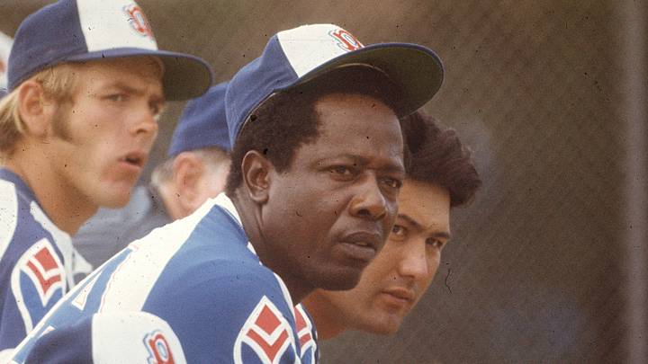 Hank Aaron watches a game from the dugout.

Hank Aaron