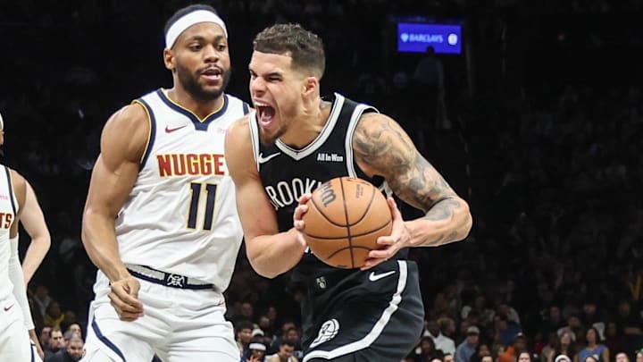 Jan 4, 2026; Brooklyn, New York, USA;  Brooklyn Nets forward Michael Porter Jr. (17) looks to drive past Denver Nuggets guard Bruce Brown (11) in the third quarter at Barclays Center. Mandatory Credit: Wendell Cruz-Imagn Images