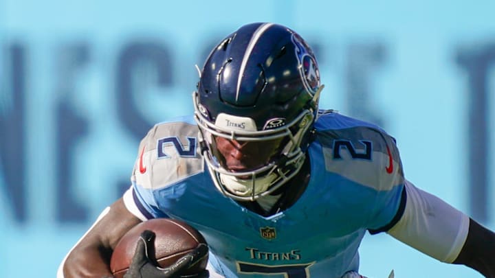 Tennessee Titans running back Tyjae Spears is tackled by Houston Texans linebacker E.J. Speed.