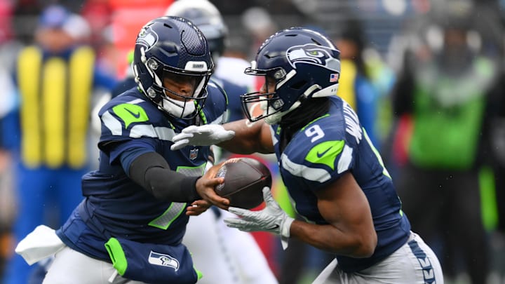 Nov 24, 2024; Seattle, Washington, USA; Seattle Seahawks quarterback Geno Smith (7) hands the ball off to running back Kenneth Walker III (9) during the first half against the Arizona Cardinals at Lumen Field.