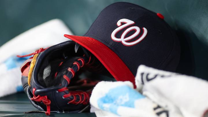 Dark blue Washington Nationals hat on top of a black mitt Dark blue Washington Nationals hat on top of a black mitt