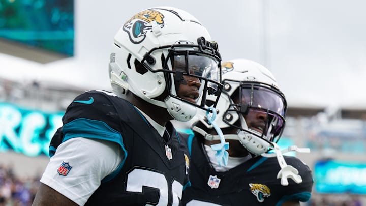 Nov 10, 2024; Jacksonville, Florida, USA; Jacksonville Jaguars cornerback Montaric Brown (30) and safety Darnell Savage (6) celebrates an interception against the Minnesota Vikings in the second quarter at EverBank Stadium. Mandatory Credit: Jeremy Reper-Imagn Images
