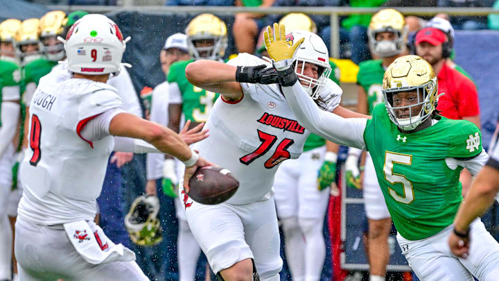 Sep 28, 2024; South Bend, Indiana, USA; Notre Dame Fighting Irish defenisve lineman Boubacar Traore (5) pressures Louisville Cardinals quarterback Tyler Shough (9) in the first quarter at Notre Dame Stadium. 