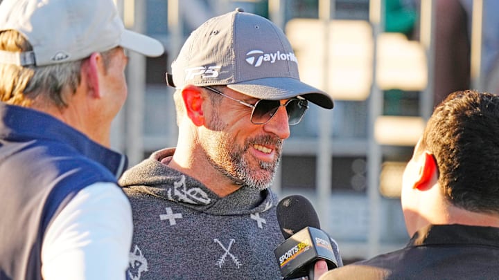 FeJets quarterback Aaron Rodgers talks with the press on the first tee box during the Phoenix Open Annexus Pro-Am at TPC Scottsdale.
