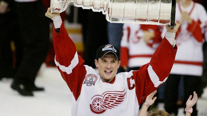 Steve Yzerman holds up the Stanley Cup with his daughter Isabella after winning the Cup for the third time after a 3-1 victory over the Carolina Hurricanes on June 13, 2002, at Joe Louis Arena in Detroit, MI.