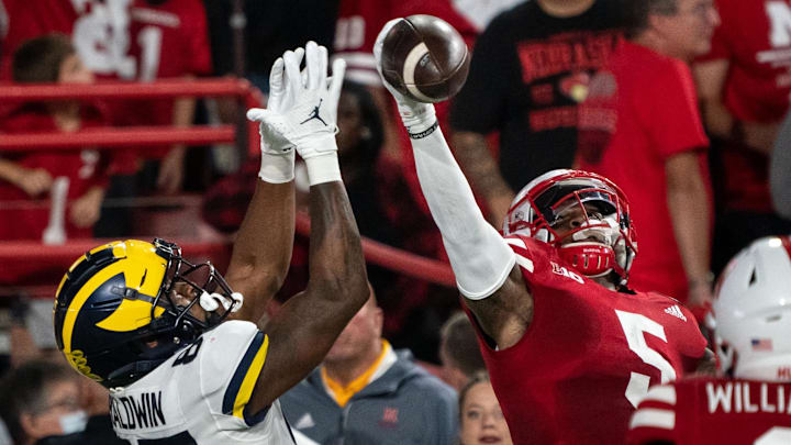 Nebraska Cornhuskers cornerback Cam Taylor-Britt breaks up a pass to Michigan Wolverines wide receiver Daylen Baldwin.