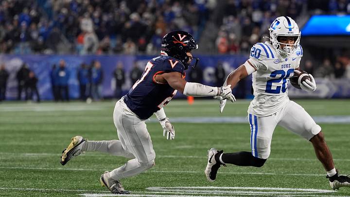 Dec 6, 2025; Charlotte, NC, USA; Duke Blue Devils running back Nate Sheppard (20) tries to outrun Virginia Cavaliers safety Devin Neal (27) during the second half during the 2025 ACC Championship game at Bank of America Stadium. Mandatory Credit: Jim Dedmon-Imagn Images Dec 6, 2025; Charlotte, NC, USA; Duke Blue Devils running back Nate Sheppard (20) tries to outrun Virginia Cavaliers safety Devin Neal (27) during the second half during the 2025 ACC Championship game at Bank of America Stadium. Mandatory Credit: Jim Dedmon-Imagn Images