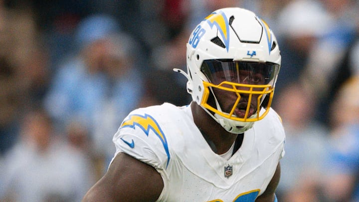 Nov 2, 2025; Nashville, Tennessee, USA;  Los Angeles Chargers linebacker Odafe Oweh (98) celebrates his sack with linebacker Tuli Tuipulotu (45) against the Tennessee Titans during the second half at Nissan Stadium. Mandatory Credit: Steve Roberts-Imagn Images