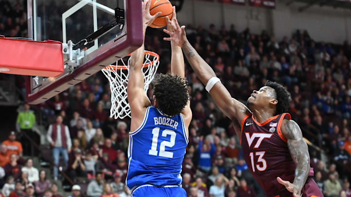 Jan 31, 2026; Blacksburg, Virginia, USA;  Duke Blue Devils forward Cameron Boozer (12) catches a alley-oop as Virginia Tech Hokies forward Amani Hansberry (13) defends during the first half at Cassell Coliseum. Mandatory Credit: Brian Bishop-Imagn Images