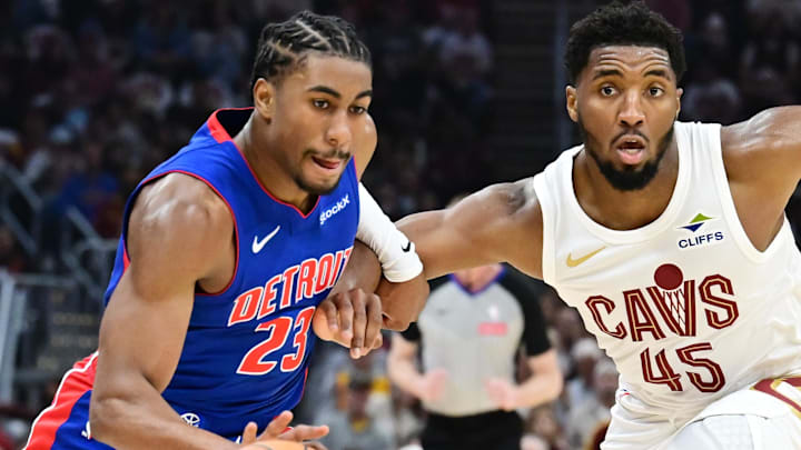 Oct 25, 2024; Cleveland, Ohio, USA; Detroit Pistons guard Jaden Ivey (23) drives to the basket against Cleveland Cavaliers guard Donovan Mitchell (45) during the first half at Rocket Mortgage FieldHouse. Mandatory Credit: Ken Blaze-Imagn Images