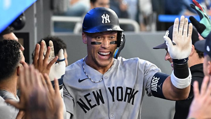 Jul 23, 2025; Toronto, Ontario, CAN; New York Yankees designated hitter Aaron Judge (99) celebrates with team mates in the dugout after hitting a two run home run against the Toronto Blue Jays in the sixth inning at Rogers Centre. Jul 23, 2025; Toronto, Ontario, CAN; New York Yankees designated hitter Aaron Judge (99) celebrates with team mates in the dugout after hitting a two run home run against the Toronto Blue Jays in the sixth inning at Rogers Centre.