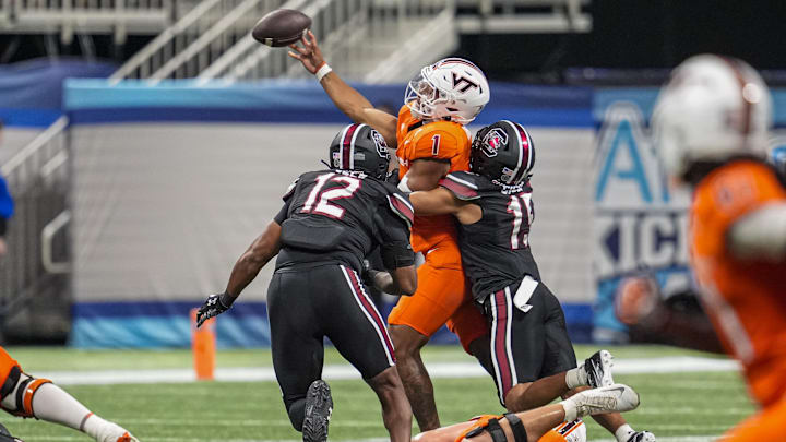 Aug 31, 2025; Atlanta, Ga.; Virginia Tech quarterback Kyron Drones (1) is hit by South Carolina defensive back Brandon Cisse (15) as he releases the ball. Aug 31, 2025; Atlanta, Ga.; Virginia Tech quarterback Kyron Drones (1) is hit by South Carolina defensive back Brandon Cisse (15) as he releases the ball.