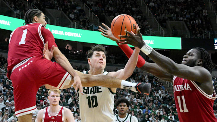 Feb 11, 2025; East Lansing, Michigan, USA;  Michigan State Spartans center Szymon Zapala (10) can’t control an offensive rebound when flanked by Indiana Hoosiers guard Myles Rice (1) and center Oumar Ballo (11) during the second half at Jack Breslin Student Events Center. Mandatory Credit: Dale Young-Imagn Images