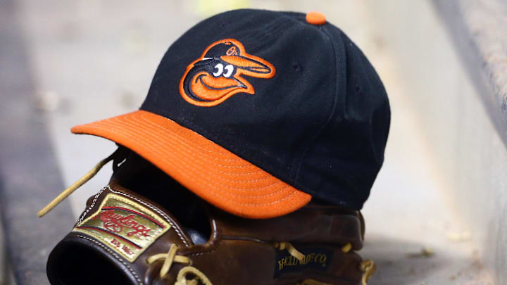 Aug. 13, 2013; Phoenix, AZ, USA: Detailed view of a Baltimore Orioles hat in the dugout on top of a Rawlings baseball glove against the Arizona Diamondbacks at Chase Field. 