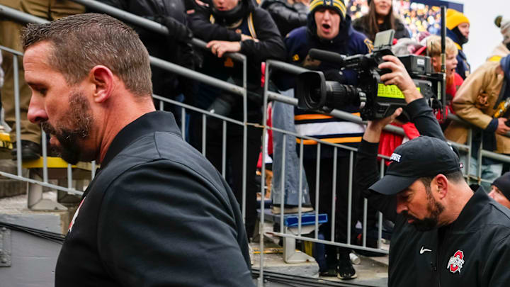 Ohio State Buckeyes offensive coordinator Brian Hartline and head coach Ryan Day walk up the tunnel after warm ups during the NCAA football game against the Michigan Wolverines at Michigan Stadium in Ann Arbor, Mich. on Nov. 29, 2025. Ohio State won 27-9.