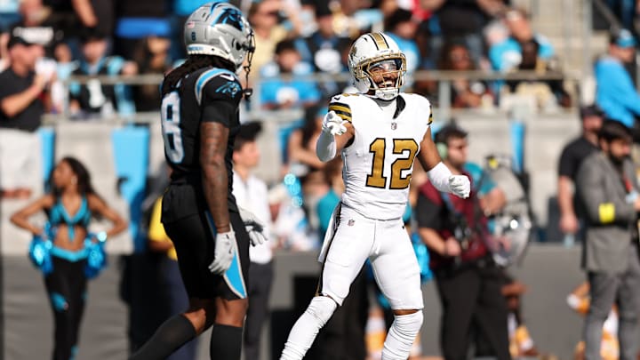 New Orleans Saints WR Chris Olave (12) laughs at Carolina Panthers CB Jaycee Horn (8) after scoring a touchdown on him on Nov. 10, 2025. 