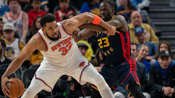 Mar 15, 2025; San Francisco, California, USA; New York Knicks center Karl-Anthony Towns (32) controls the basketball against Golden State Warriors forward Draymond Green (23) during the third quarter at Chase Center. Mandatory Credit: Neville E. Guard-Imagn Images