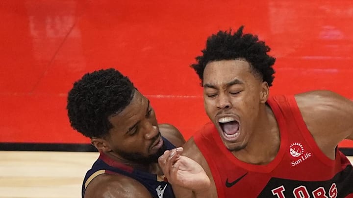 Toronto Raptors guard Scottie Barnes drives to the net against Cleveland Cavaliers guard Donovan Mitchell.