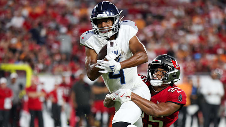 Aug 9, 2025; Tampa, Florida, USA; Tennessee Titans wide receiver Tyler Lockett (4) is brought down by Tampa Bay Buccaneers cornerback Jacob Parrish (25) in the second quarter during a preseason game at Raymond James Stadium. Aug 9, 2025; Tampa, Florida, USA; Tennessee Titans wide receiver Tyler Lockett (4) is brought down by Tampa Bay Buccaneers cornerback Jacob Parrish (25) in the second quarter during a preseason game at Raymond James Stadium.