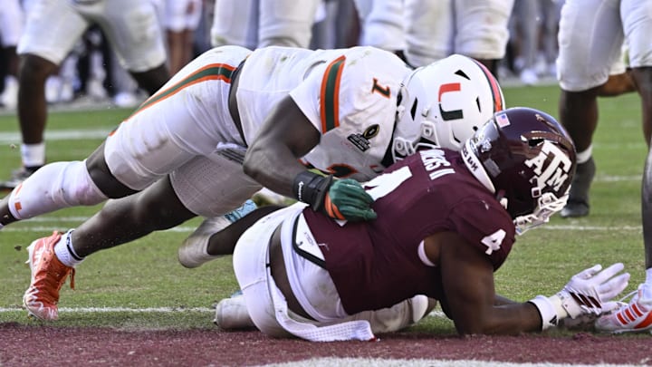 Miami Hurricanes linebacker Mohamed Toure (1) hits Texas A&M Aggies running back Rueben Owens II (4) at the goal line during the second half of the first round game of the CFP National Playoff at Kyle Field.