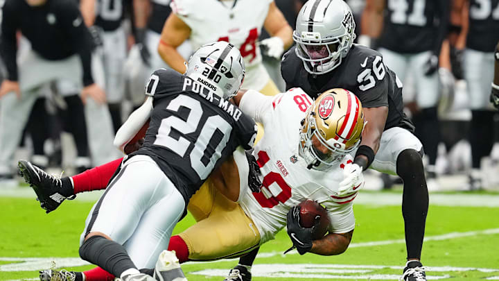 Aug 16, 2025; Paradise, Nevada, USA; San Francisco 49ers wide receiver Isaiah Hodgins (18) is tackled by Las Vegas Raiders cornerback Kyu Blu Kelly (36) and Las Vegas Raiders safety Isaiah Pola-Mao (20) during the first quarter at Allegiant Stadium. Mandatory Credit: Stephen R. Sylvanie-Imagn Images Aug 16, 2025; Paradise, Nevada, USA; San Francisco 49ers wide receiver Isaiah Hodgins (18) is tackled by Las Vegas Raiders cornerback Kyu Blu Kelly (36) and Las Vegas Raiders safety Isaiah Pola-Mao (20) during the first quarter at Allegiant Stadium. Mandatory Credit: Stephen R. Sylvanie-Imagn Images