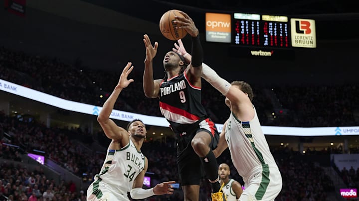 Jan 31, 2024; Portland, Oregon, USA; Portland Trail Blazers forward Jerami Grant (9) scores a basket during the second half against Milwaukee Bucks forward Giannis Antetokounmpo (34) and center Brook Lopez (11) at Moda Center. Mandatory Credit: Troy Wayrynen-Imagn Images