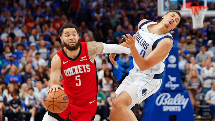 Apr 7, 2024; Dallas, Texas, USA; Dallas Mavericks guard Dante Exum (0) is called for a foul against Houston Rockets guard Fred VanVleet (5) during the fourth quarter at American Airlines Center. Mandatory Credit: Andrew Dieb-Imagn Images