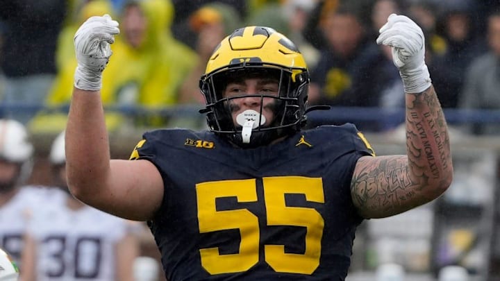 Michigan defensive lineman Mason Graham celebrates after sacking Minnesota quarterback Max Brosmer, in the background, during first-half action between Michigan and Minnesota at Michigan Stadium in Ann Arbor on Saturday, Sept. 28, 2024.