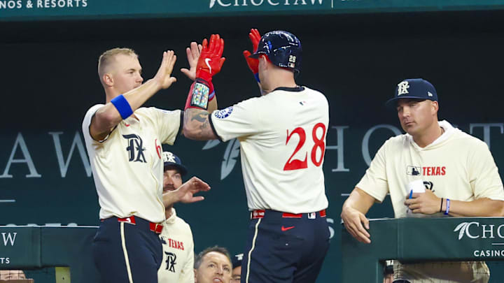 Mar 28, 2025; Arlington, Texas, USA;  Texas Rangers catcher Jonah Heim (28) celebrates with Texas Rangers third baseman Josh Jung (6) after hitting a home run during the third inning against the Boston Red Sox at Globe Life Field. 