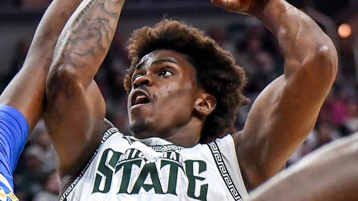 Michigan State's Coen Carr, right, shoots UCLA's Xavier Booker defends during the first half on Tuesday, Feb. 17, 2026, at the Breslin Center in East Lansing.