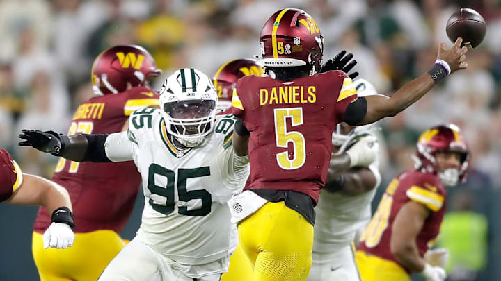 Green Bay Packers defensive tackle Devonte Wyatt (95) pressures Washington Commanders quarterback Jayden Daniels (5) on Thursday, September 11, 2025, at Lambeau Field in Green Bay, Wis. The Packers defeated the Commanders 27-18.Wm.