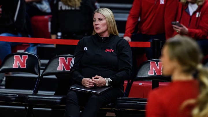 In her first game, coach Dani Busboom Kelly watches pre-game warmups. 
