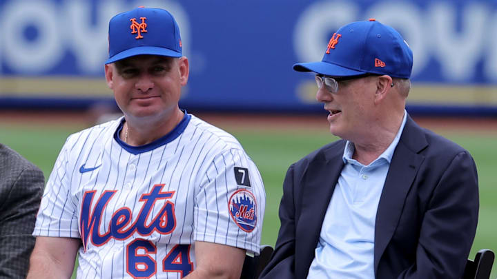 Jul 19, 2025; New York City, New York, USA; New York Mets manager Carlos Mendoza (64) talks to owner Steve Cohen (center) and his wife Alex Cohen (right) during the number retirement ceremony for former third baseman David Wright (not pictured) before a game against the Cincinnati Reds at Citi Field. Mandatory Credit: Brad Penner-Imagn Images