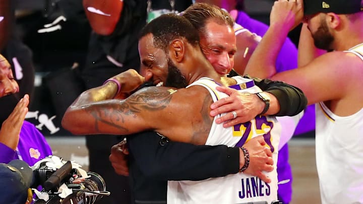 Oct 11, 2020; Lake Buena Vista, Florida, USA; Los Angeles Lakers forward LeBron James (23) hugs general manager Rob Pelinka after game six of the 2020 NBA Finals at AdventHealth Arena. The Los Angeles Lakers won 106-93 to win the series. Mandatory Credit: Kim Klement-Imagn Images