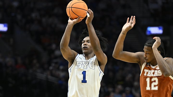 Mar 19, 2026; Portland, OR, USA; BYU Cougars guard Robert Wright III (1) shoots against Texas Longhorns guard Tramon Mark (12) in the first half during a first round game of the men's 2026 NCAA Tournament at Moda Center. Mandatory Credit: Craig Strobeck-Imagn Images
