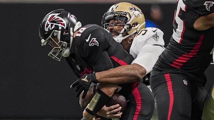 Jan 4, 2026; Atlanta, Georgia, USA; Atlanta Falcons quarterback Kirk Cousins (18) is tackled for a loss by New Orleans Saints defensive end Cameron Jordan (94) during the first quarter at Mercedes-Benz Stadium. Mandatory Credit: Dale Zanine-Imagn Images
