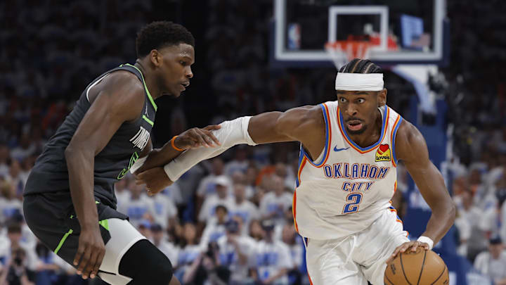 May 20, 2025; Oklahoma City, Oklahoma, USA; Oklahoma City Thunder guard Shai Gilgeous-Alexander (2) drives against Minnesota Timberwolves guard Anthony Edwards (5) in the fourth quarter during game one of the western conference finals for the 2025 NBA Playoffs at Paycom Center. Mandatory Credit: Alonzo Adams-Imagn Images