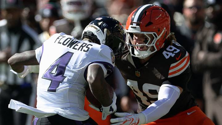 Oct 18, 2026; Cleveland, Ohio, USA;  Baltimore Ravens wide receiver Zay Flowers (4) runs through the tackle of Cleveland Browns linebacker Carson Schwesinger (49) in the second quarter at Huntington Bank Field.  Mandatory Credit: Scott Galvin-Imagn Images