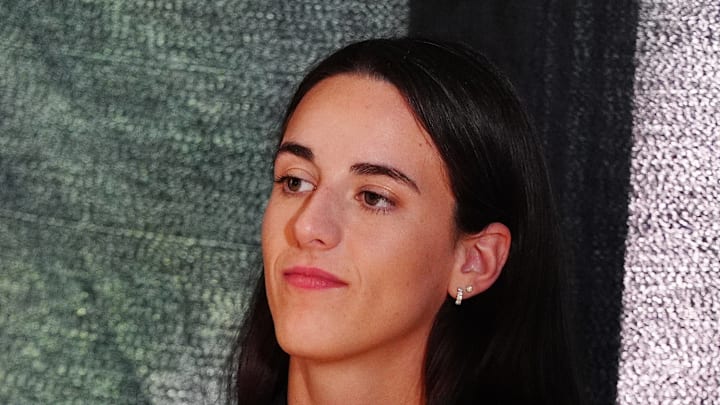 Caitlin Clark waits to speak at a press conference.